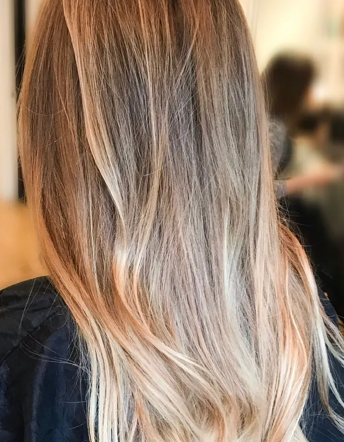 The same hair after blonde balayage, with soft waves